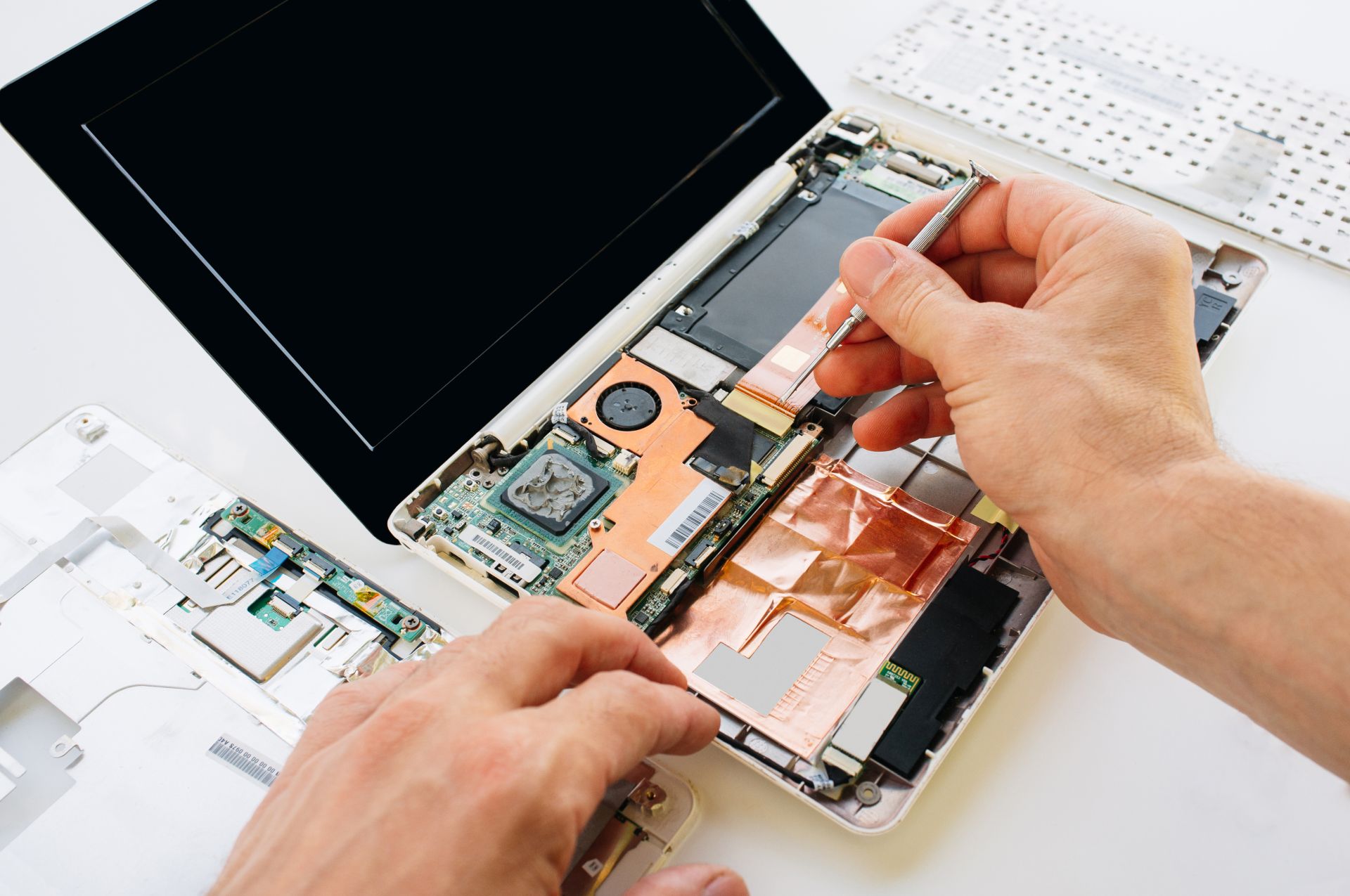 The engineer repairs the laptop (pc, computer) and the motherboard. Installs the equipment (cpu)